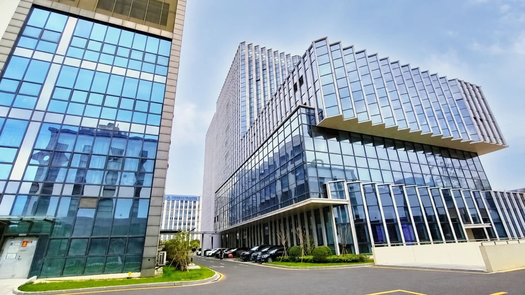 Exterior view of LotusBio company premises with glass-fronted buildings and landscaped grounds